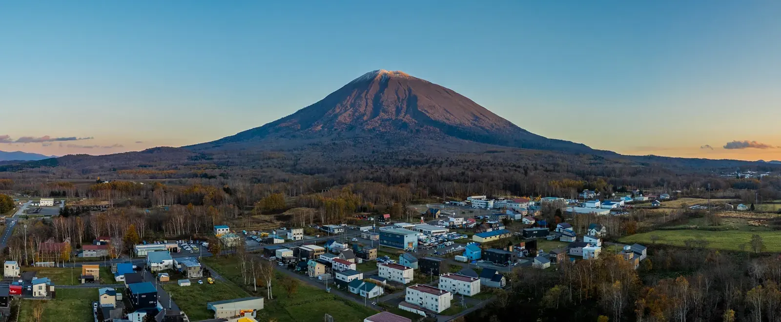 Aerial view of Mt Yotei at dusk above the town of Kutchan in autumn